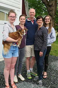 Juliet, Stefanie, David, Jennifer, and Sofia Feltwell, with their dog Chester